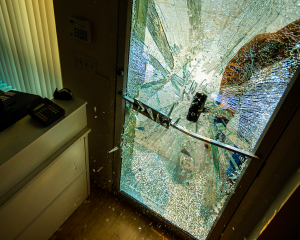 Someone bashing in the glass door in a store